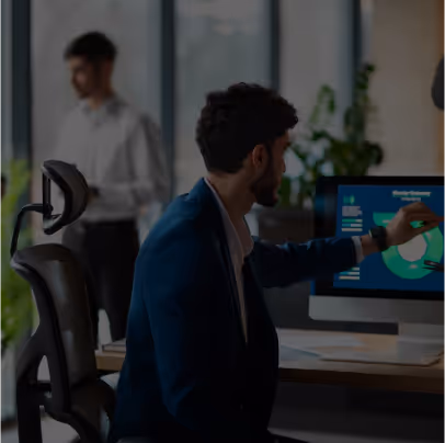 An image depicting a modern office setting with a professional working on a computer displaying a circular economy chart. Represents a dynamic and collaborative environment for digital business services.