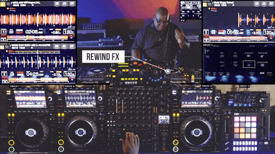 Carl Cox performing on a professional DJ setup with multiple decks, controllers, and waveforms displayed on screens. The 'Rewind FX' effect is highlighted during the mix