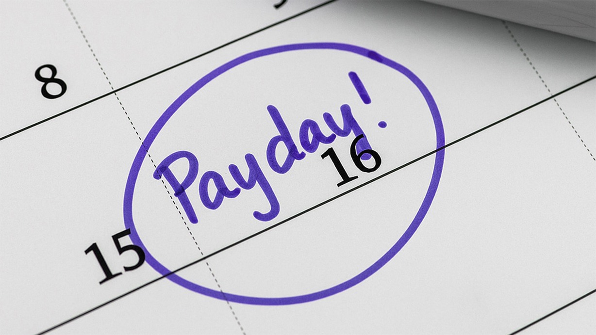 Calendar with the date 16 circled in purple and labeled payday in handwritten text