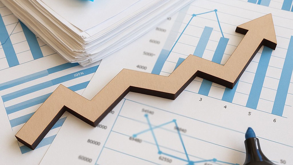 Upward arrow on financial charts and stacked documents representing business growth and success