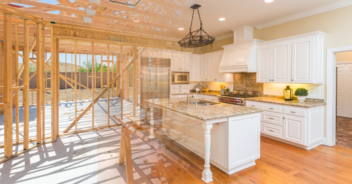 A kitchen renovation scene blending a finished kitchen with exposed wooden framing in the background.