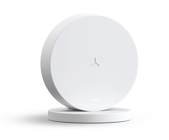 A sleek, modern white Waffle sensor device with a circular design is displayed on a round base against a neutral background.