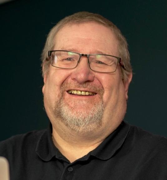 A person wearing glasses and a black shirtAI-generated content may be incorrect.