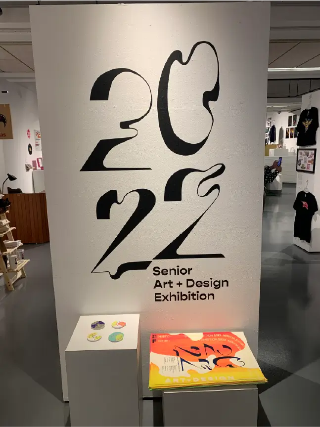 Image of the entrance to the exhibition with the type from the poster placed in vinyl onto a wall