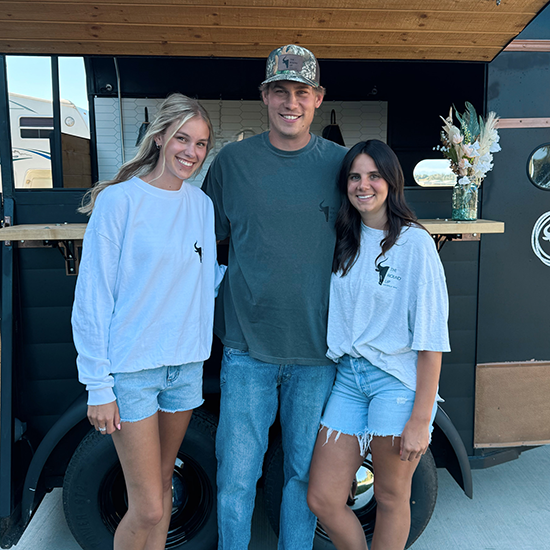 Amber, Shyann, and Dustin, the owners of The Round Up Mobile Bar with the trailer.