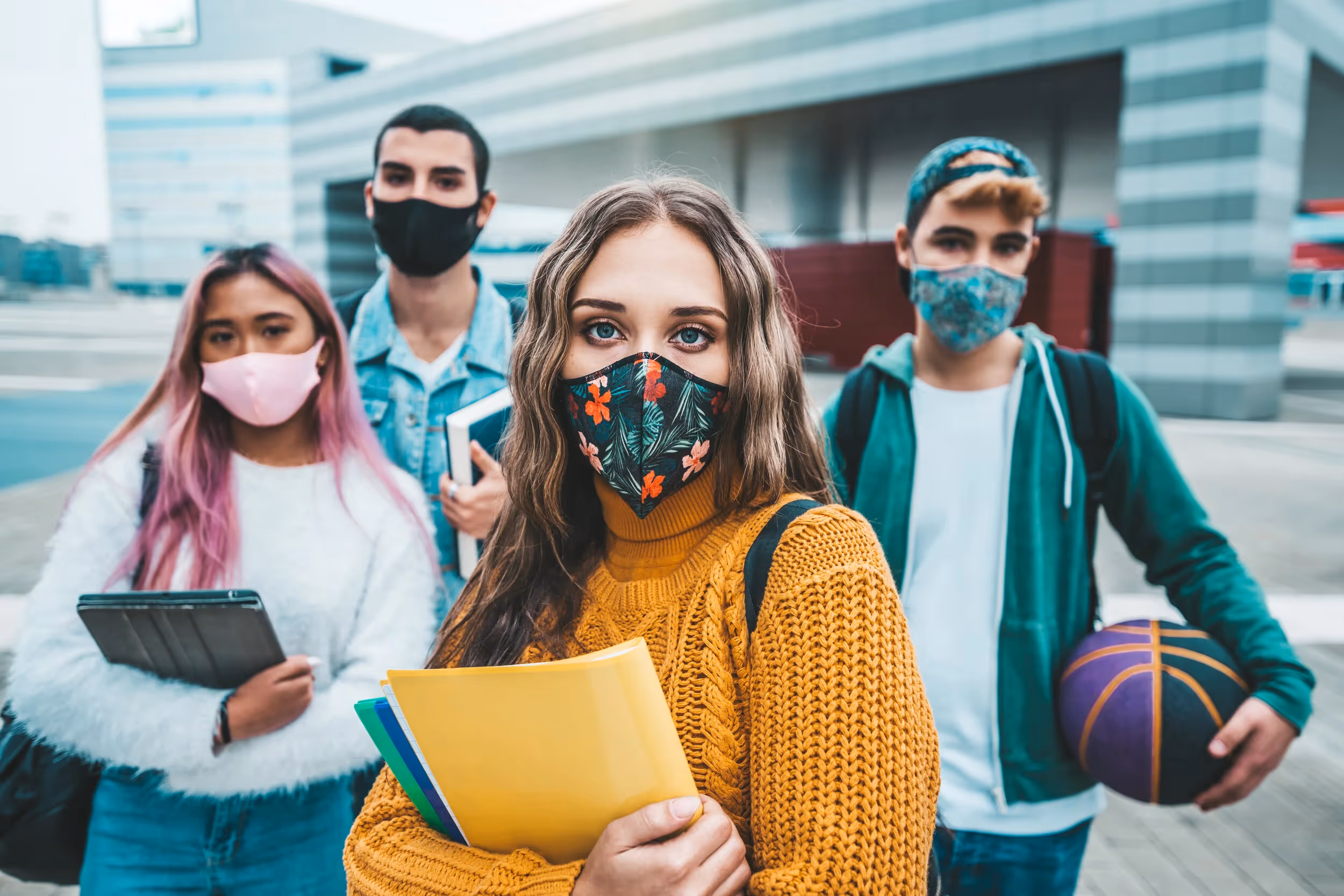 college students wearing masks in between classes