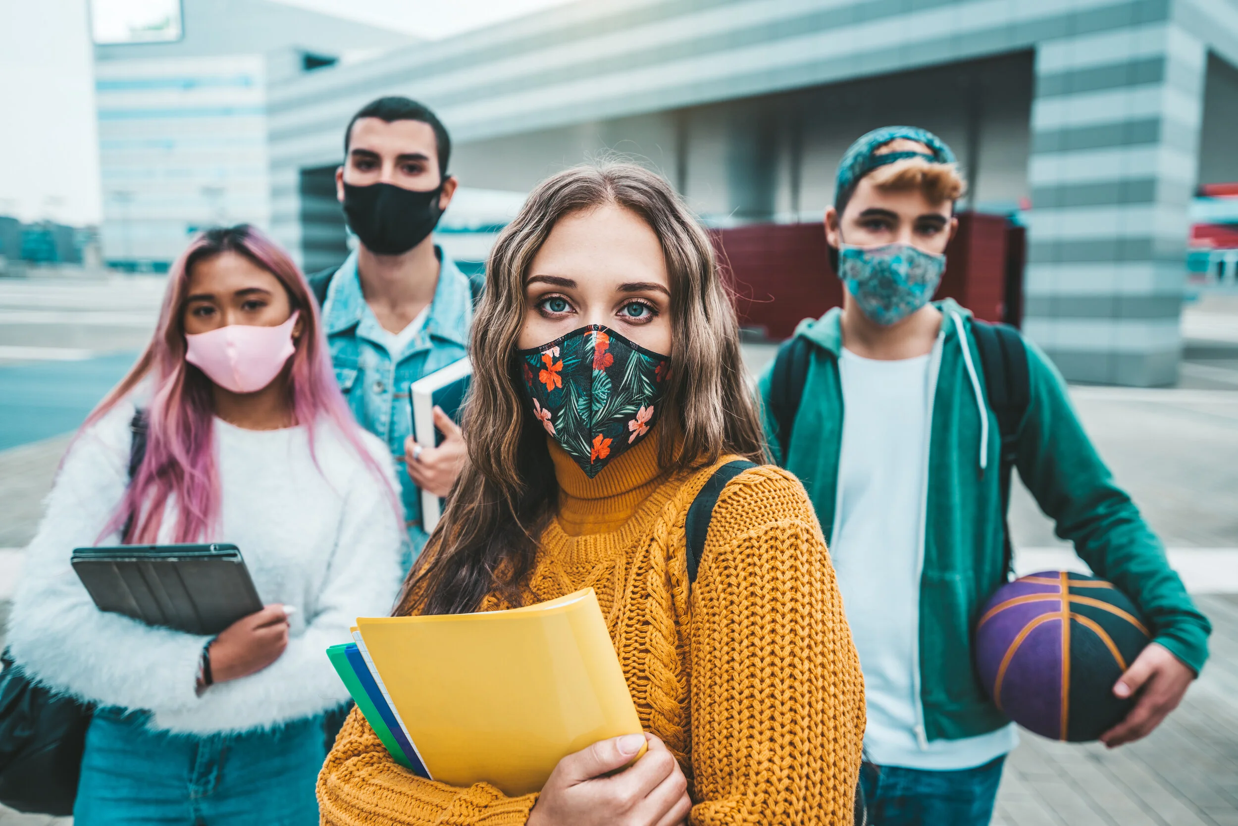 college students wearing masks in between classes
