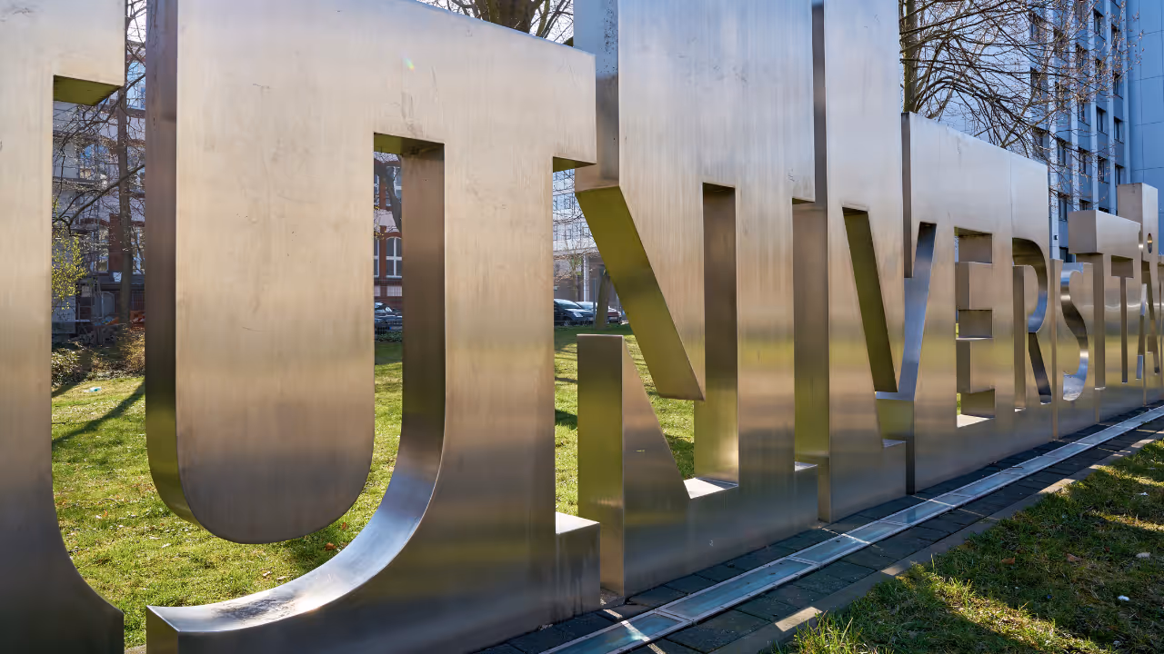 Metal sign that reads "University"