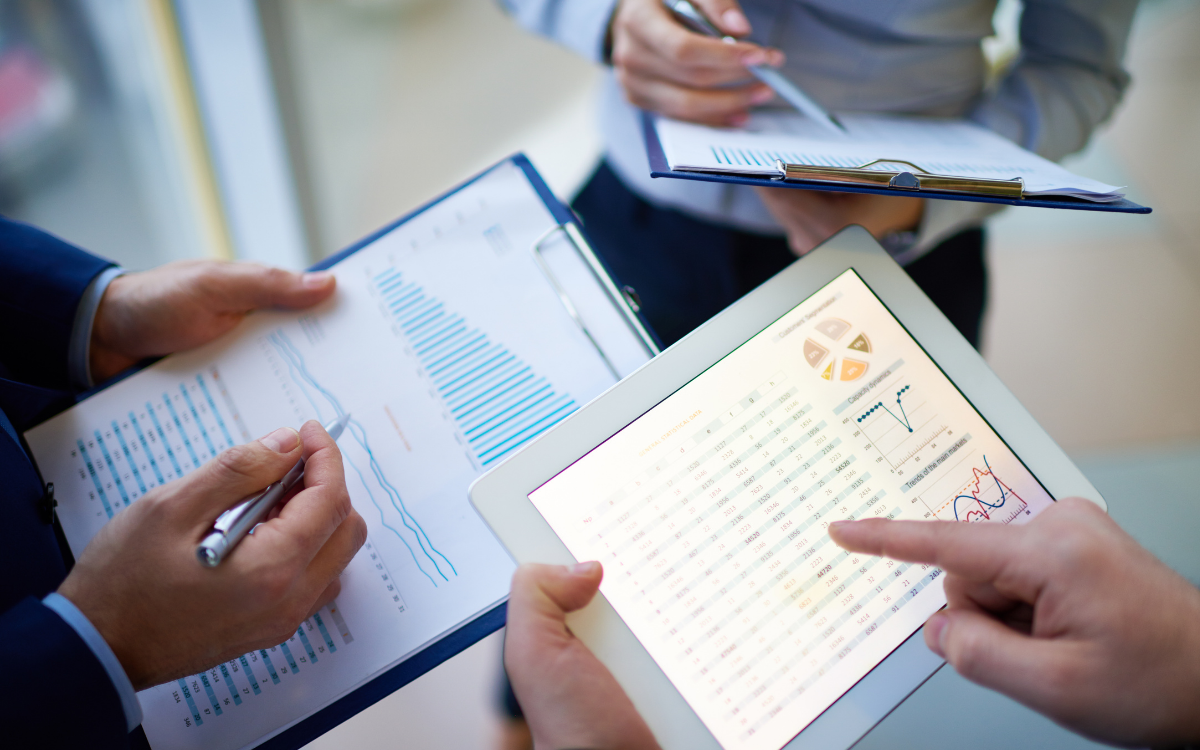 comparing notes on tablet and clipboard