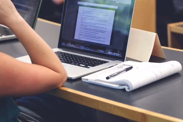 student laptop and notebook in class