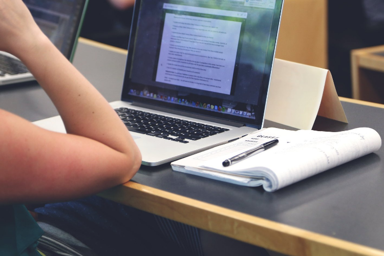 student laptop and notebook in class