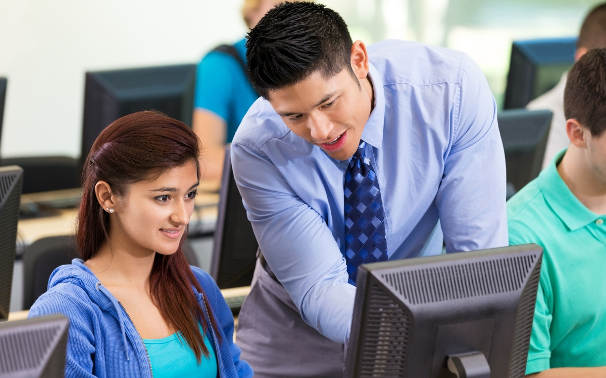 teacher helping student with math problem