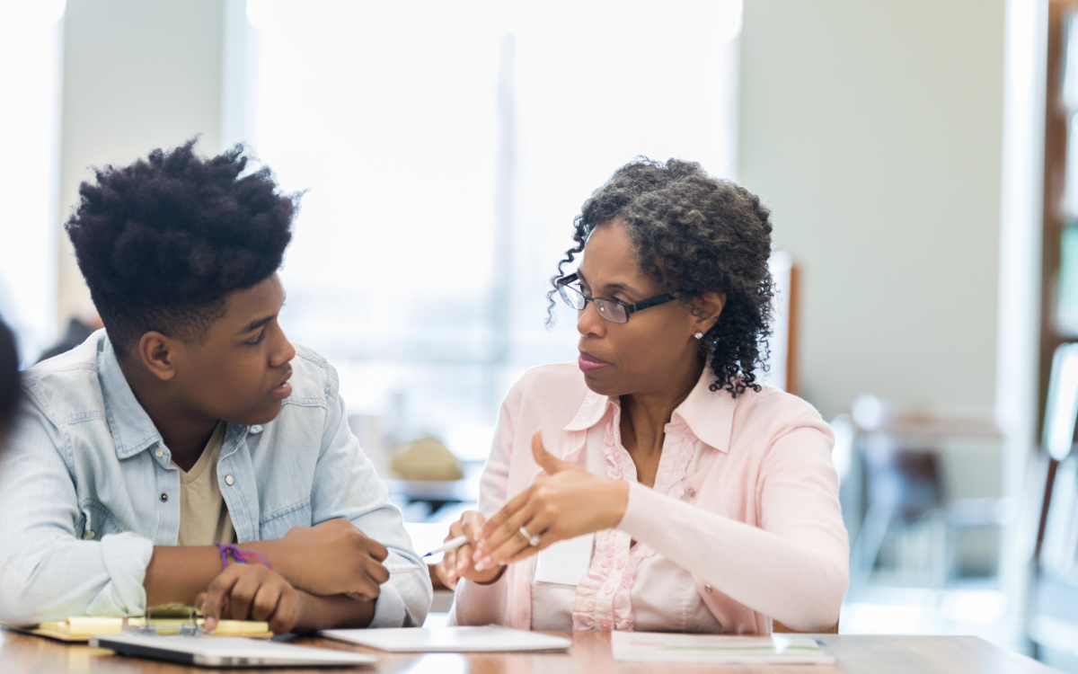 teacher talking one on one with student