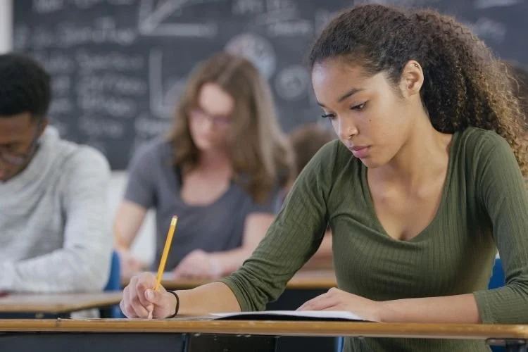 female student taking notes in class