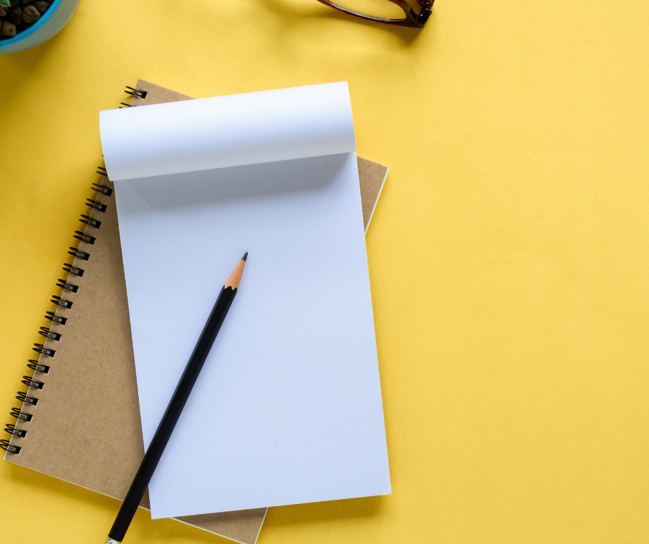 empty notebook with pencil on top