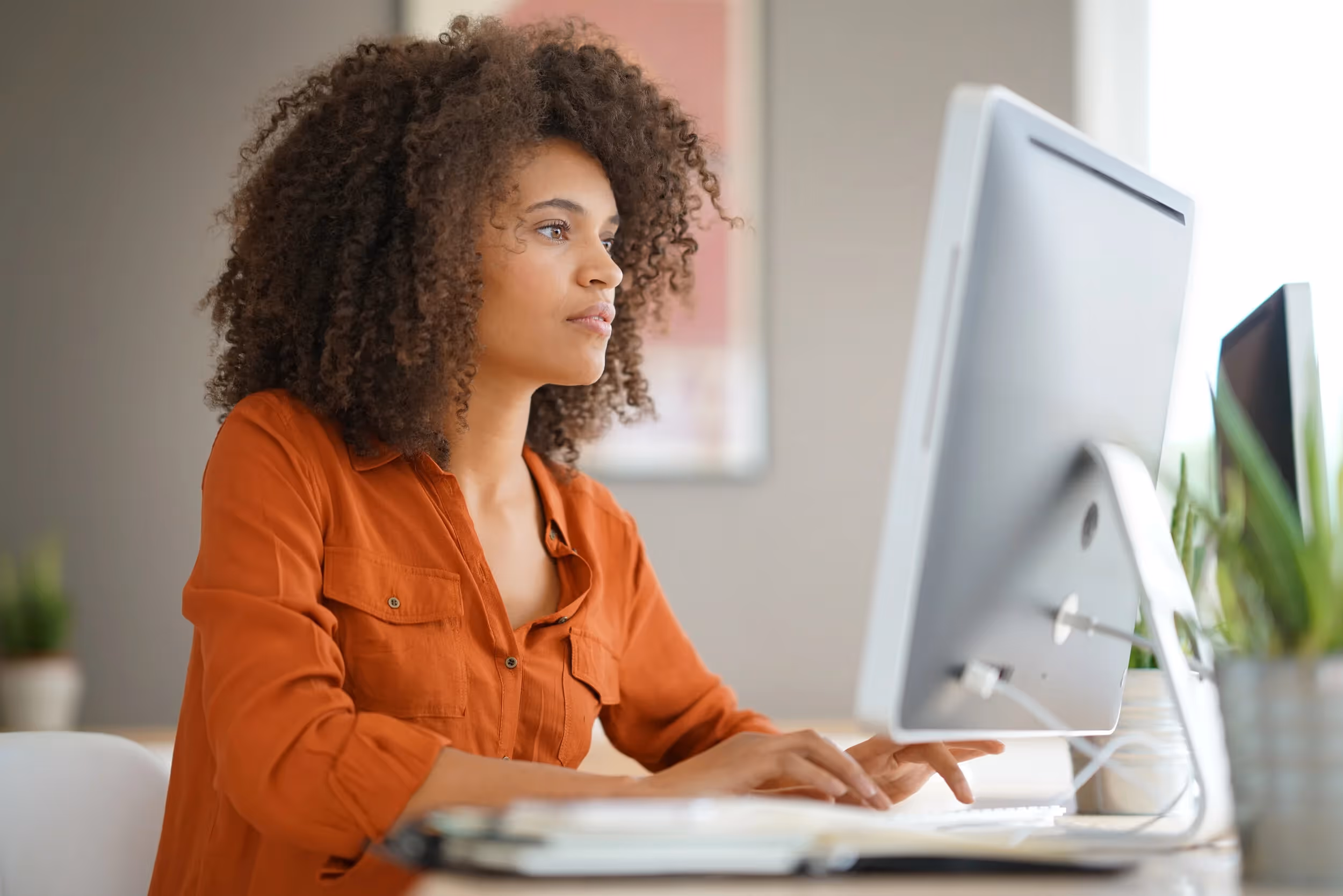 female teacher looking at computer