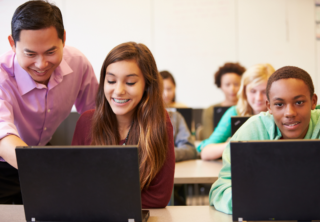students completing assignments on computers in class
