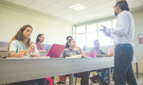 teacher discussing homework with students