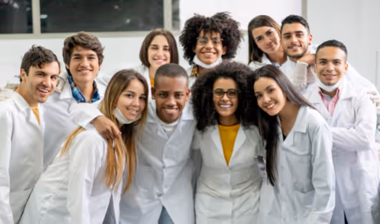 college students smiling in lab coats