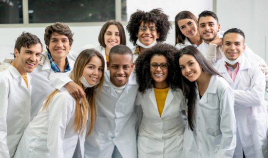 college students smiling in lab coats