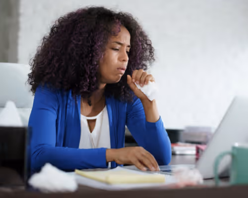 woman sick at home and working