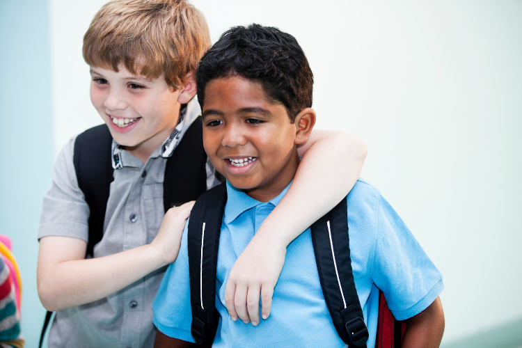 young boys smiling walking to class