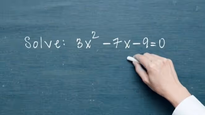 teacher writing math problem on chalk board