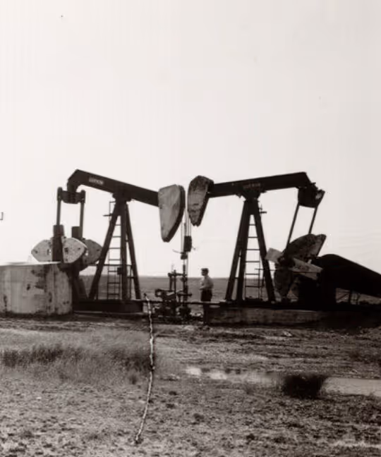 Old timey photo of pump jacks in the saskatchewan landscape