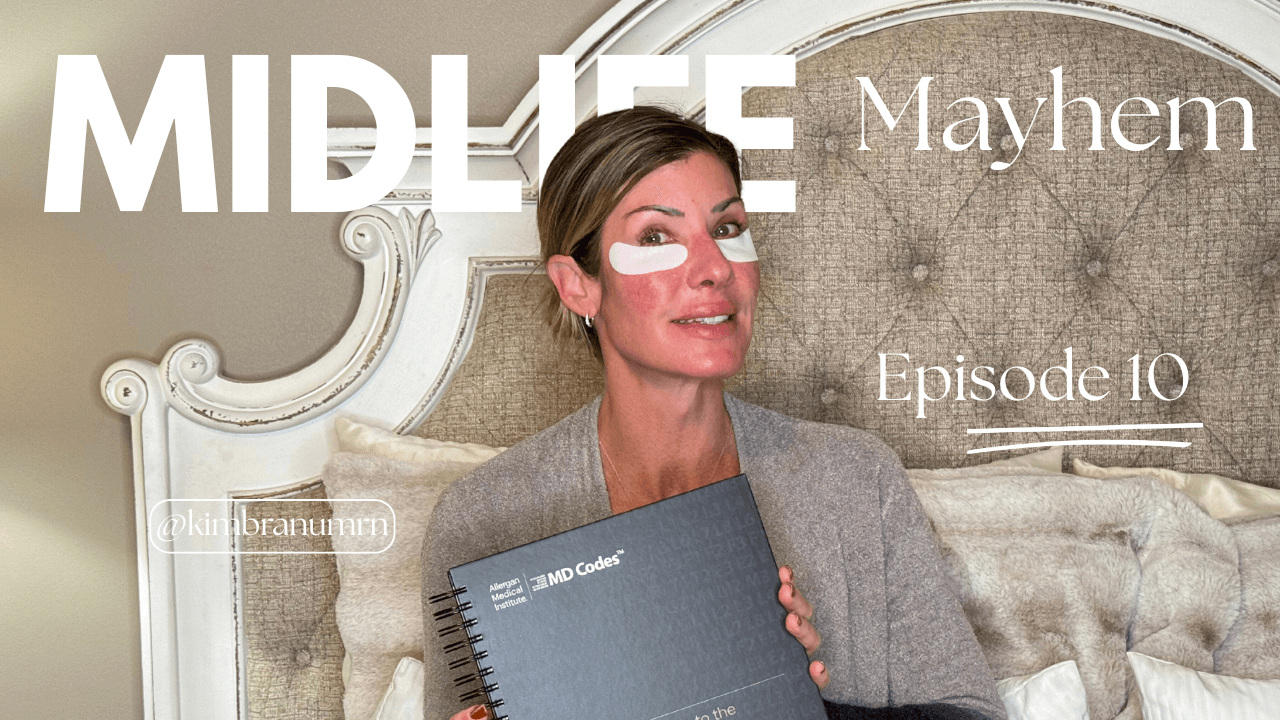 Kim Branum from Thin Space Wellness smiling with under-eye patches while holding an MD Codes book—representing Midlife Mayhem Episode 10 on strategic aesthetics and midlife wellness.