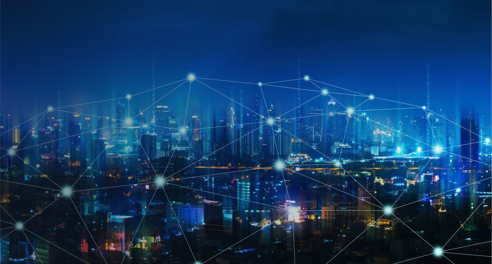 Lit up futuristic looking city skyline at night