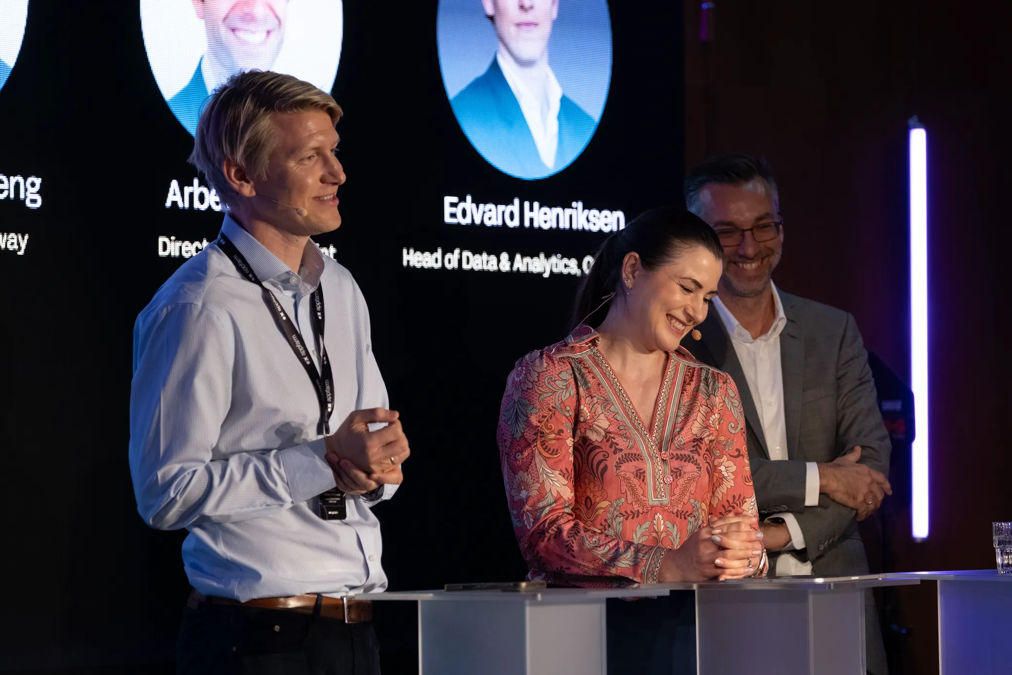 The enterprise AI adoption panel on stage at Rebel, with the speaker names on the screen behind them