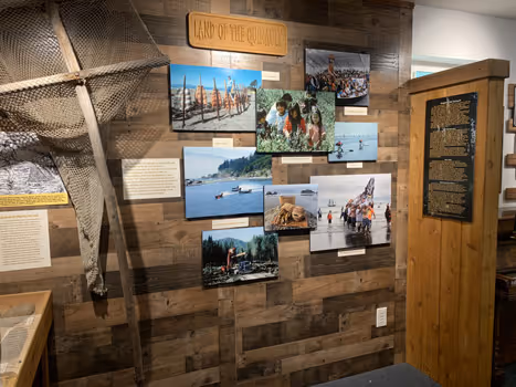 A wooden wall with pictures of people on it.