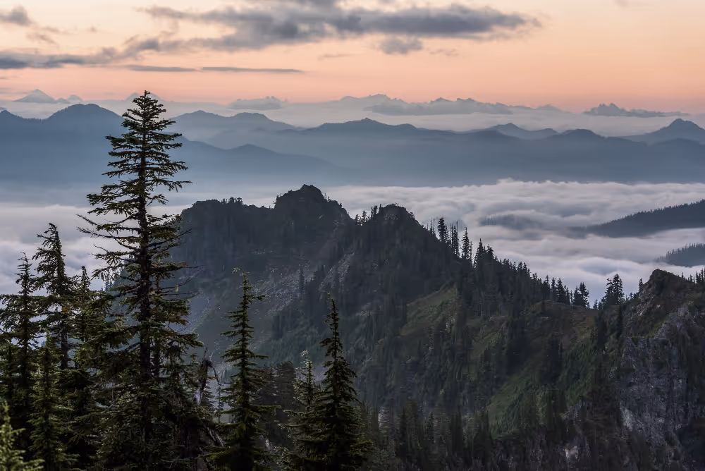 A view of a mountain range covered in fog.