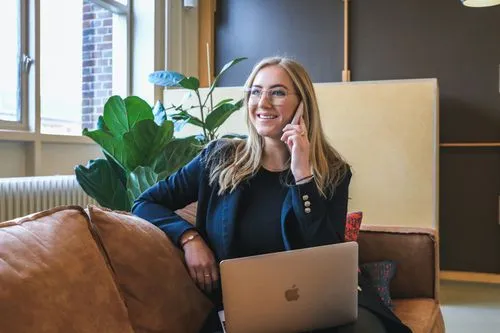 Founder on the phone with a laptop.