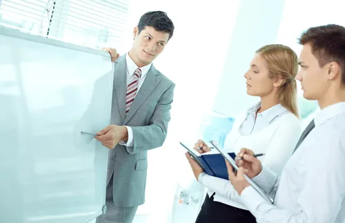 People in an office around a whiteboard