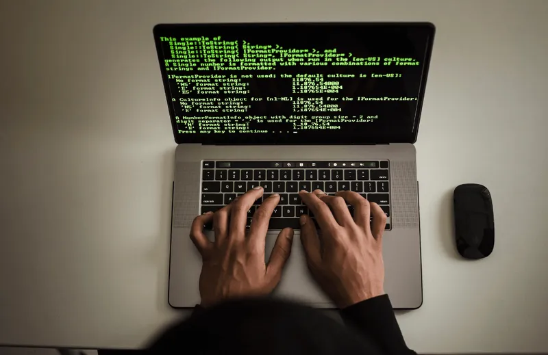 Hands on keyboard of laptop
