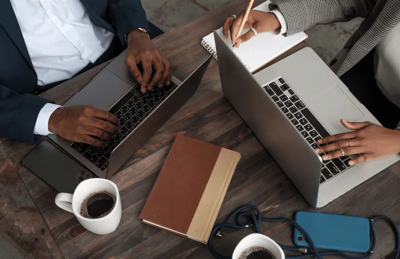People working on laptops with coffee