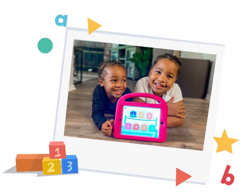 Two smiling kids using Khan Academy Kids app on tablet for interactive early learning games.