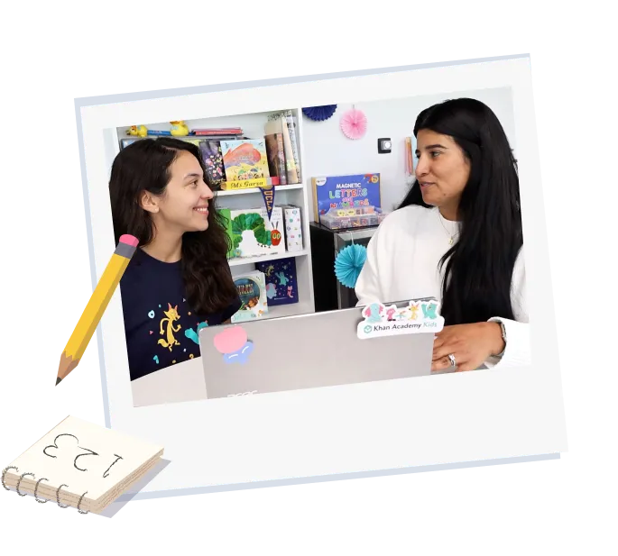 Two adults - a teacher and an implementation manager discuss a rollout plan for Khan Kids in a classroom setting. 