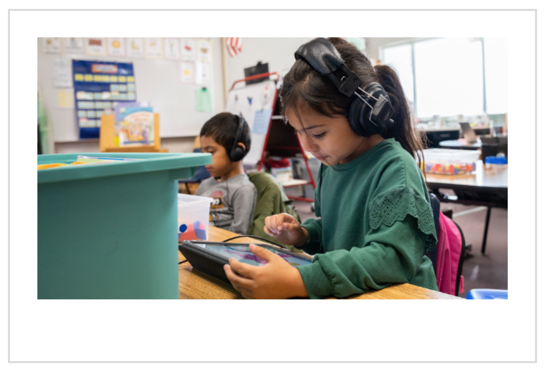 Young girl using the Khan Academy Kids app on a tablet to build early math skills. 