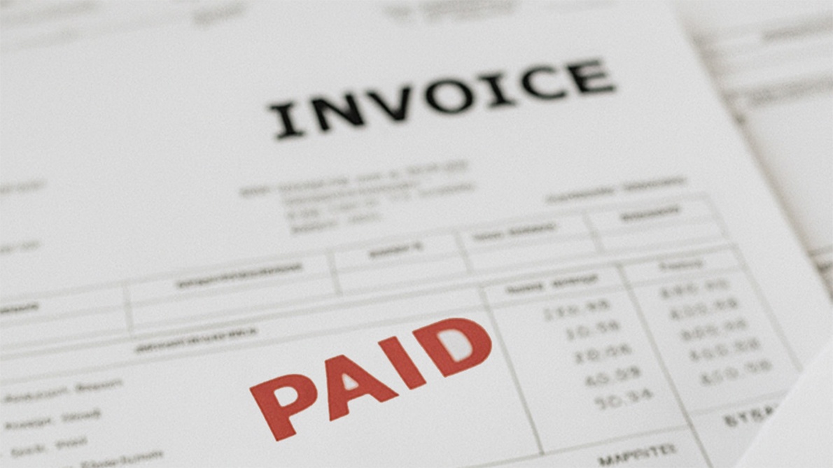 Invoice document stamped with "PAID" in bold red letters, confirming completed payment.