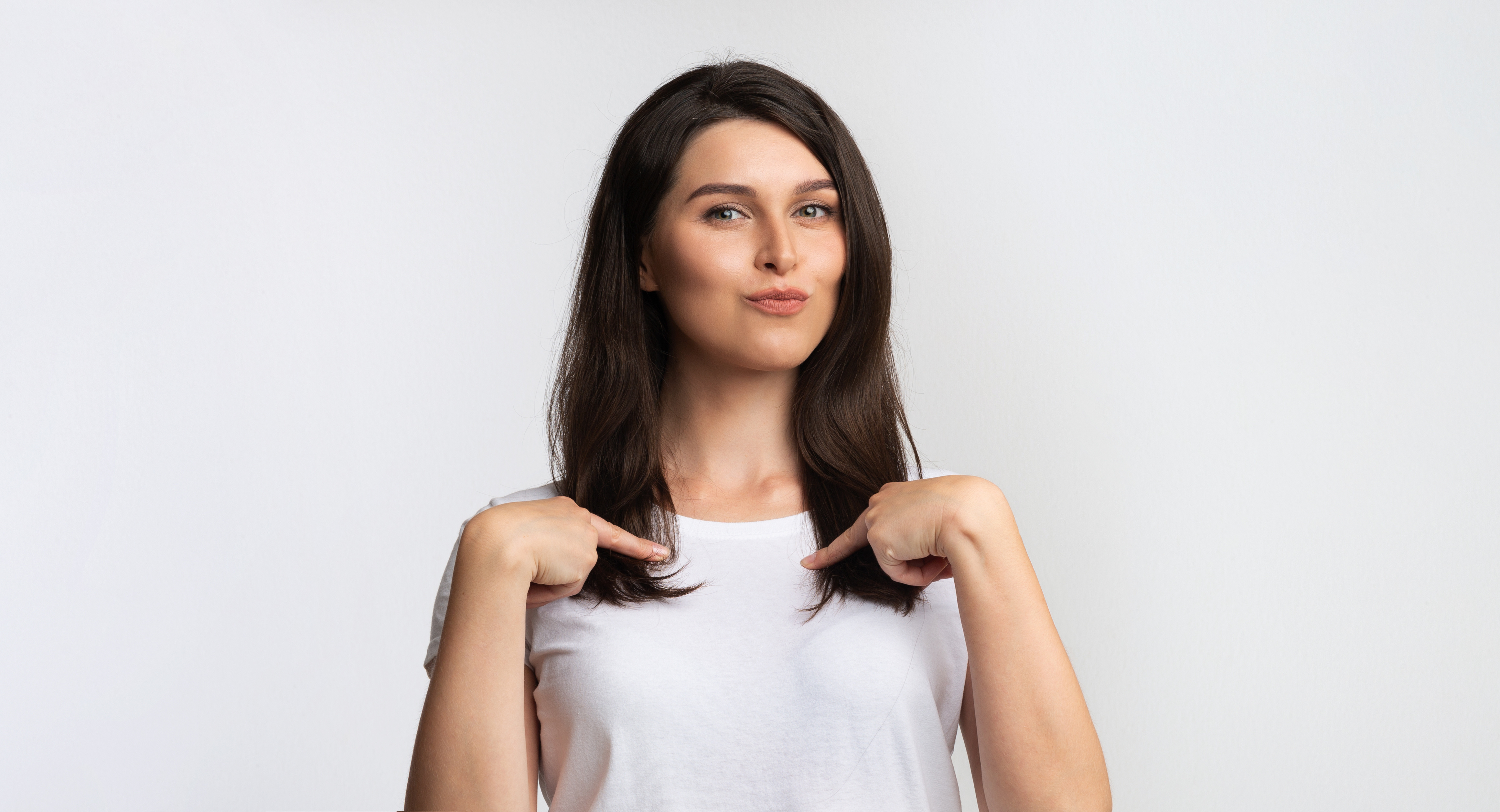 Confident woman pointing to herself, representing self-awareness and personal accountability in leadership — AWL Partners Toronto.