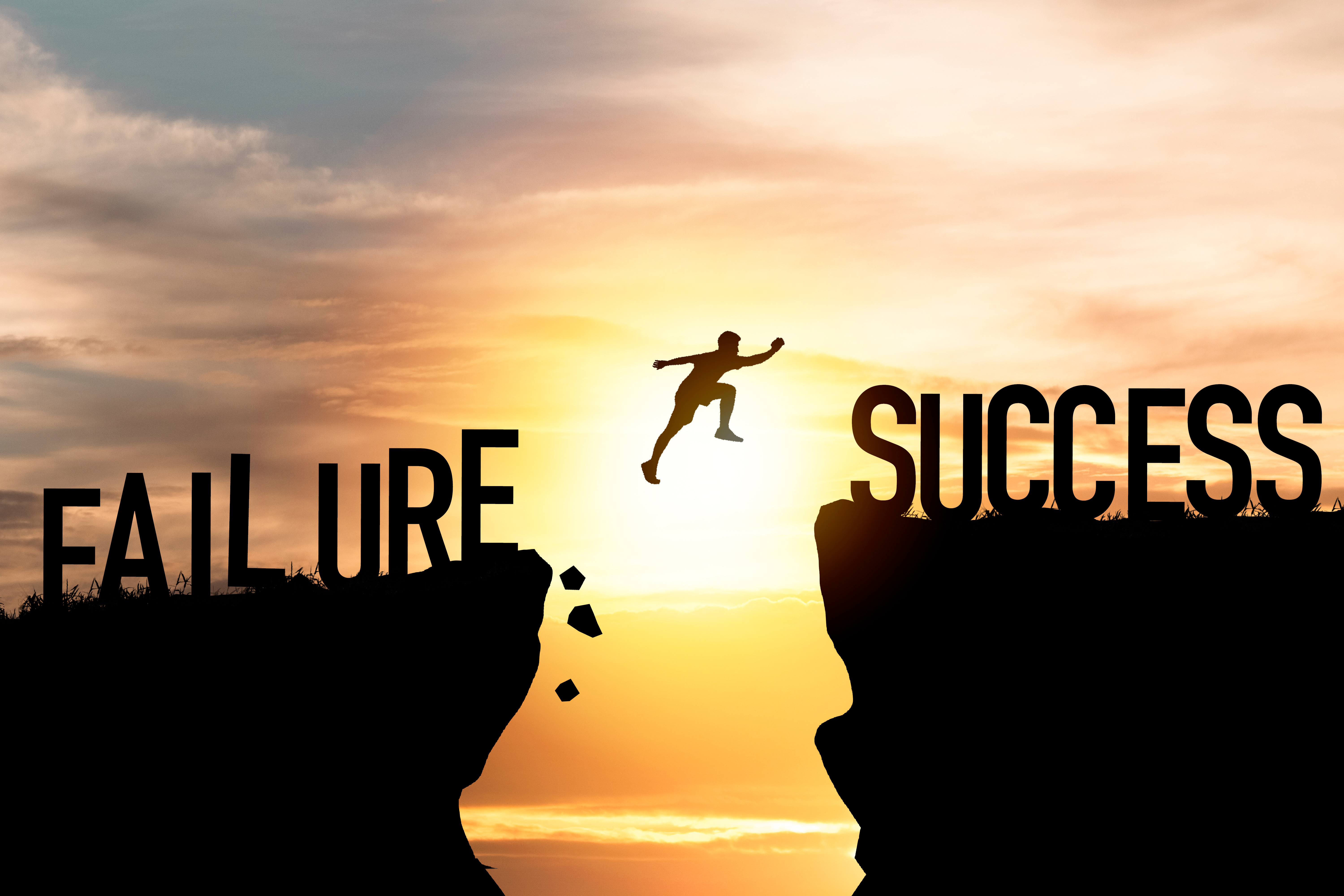 Silhouette of a person jumping from a cliff labeled “Failure” to a cliff labeled “Success” at sunrise, symbolizing resilience and leadership growth — AWL Partners, Canada.