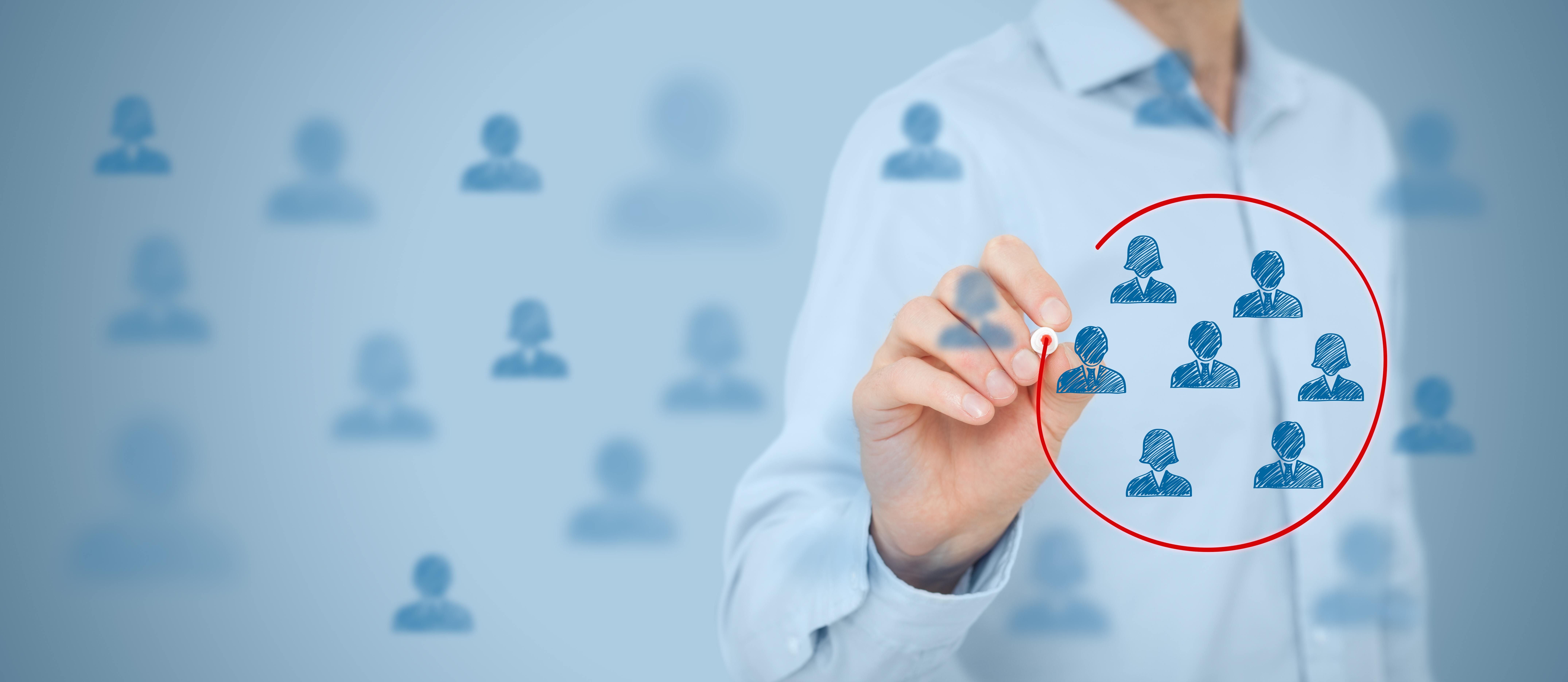 Business leader drawing a red circle around a selected group of employees, symbolizing targeted leadership development and team alignment in Toronto and the GTA.