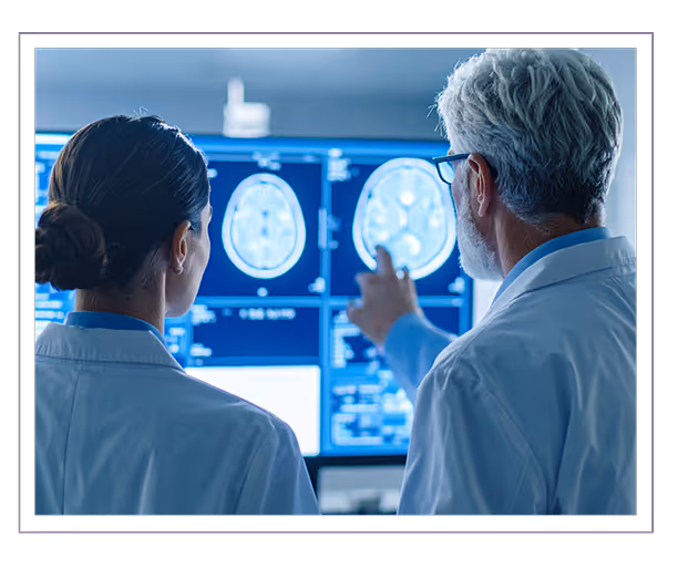 Man and woman in lab looking at screen