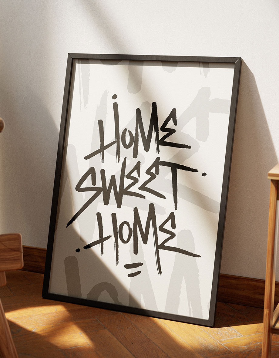 a poster in a frame leaning against a wall that says home sweet home