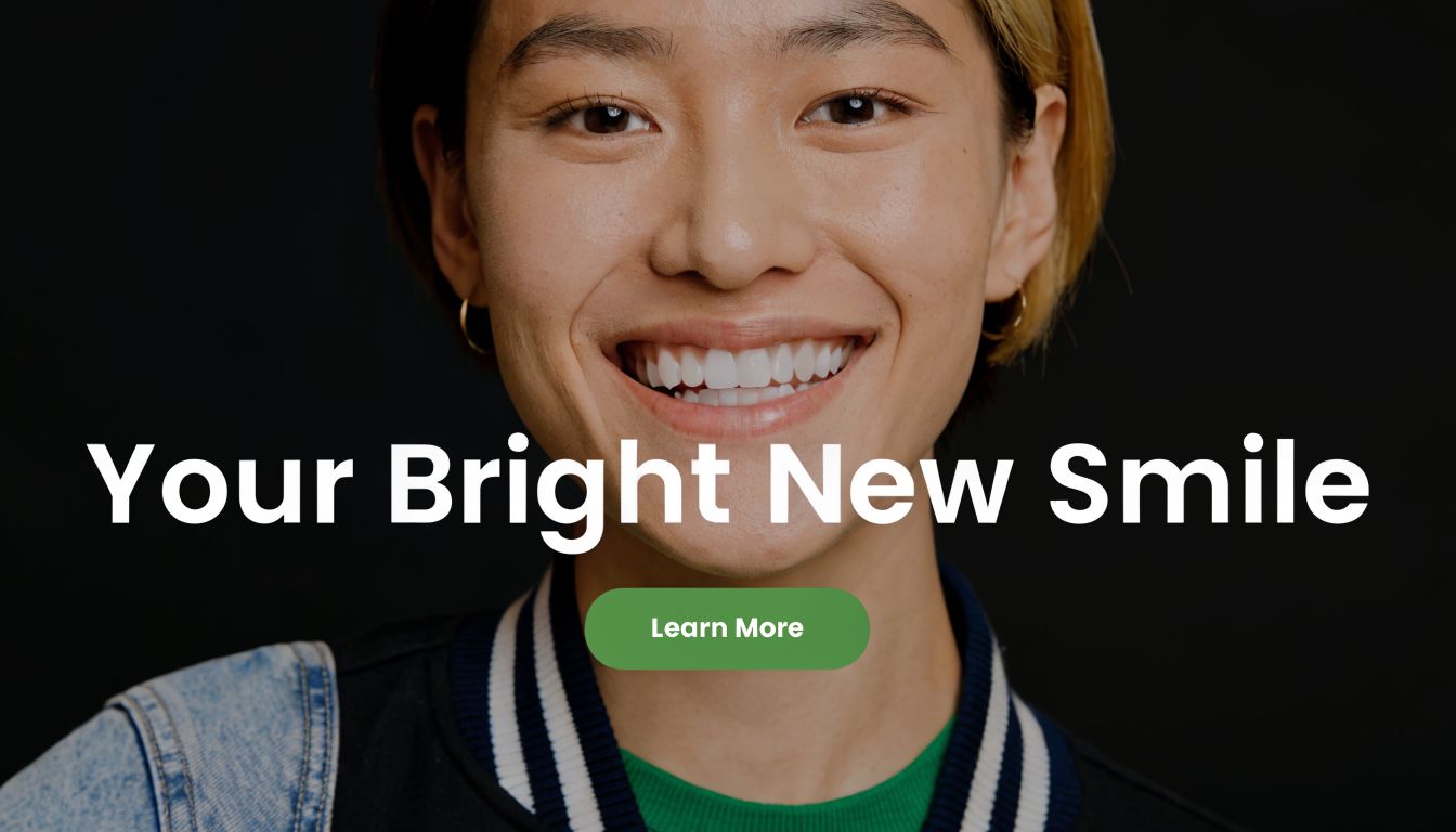 A close up of a smiling person with bright white teeth against a simple dark background.