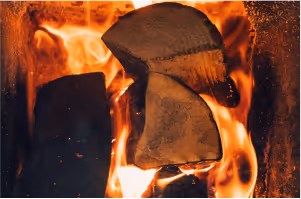 Close-up of burning logs inside the traditional wood-fired sauna stove at Sásta Sauna in Leixlip, Co. Kildare.