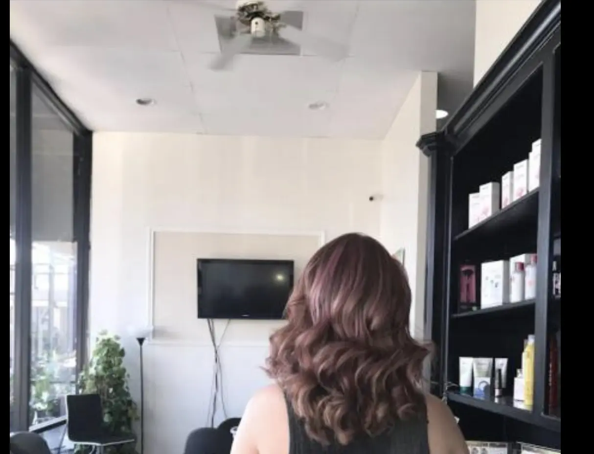 After styling: medium-length brunette hair with creamy blonde highlights, loose waves cascading down the back.