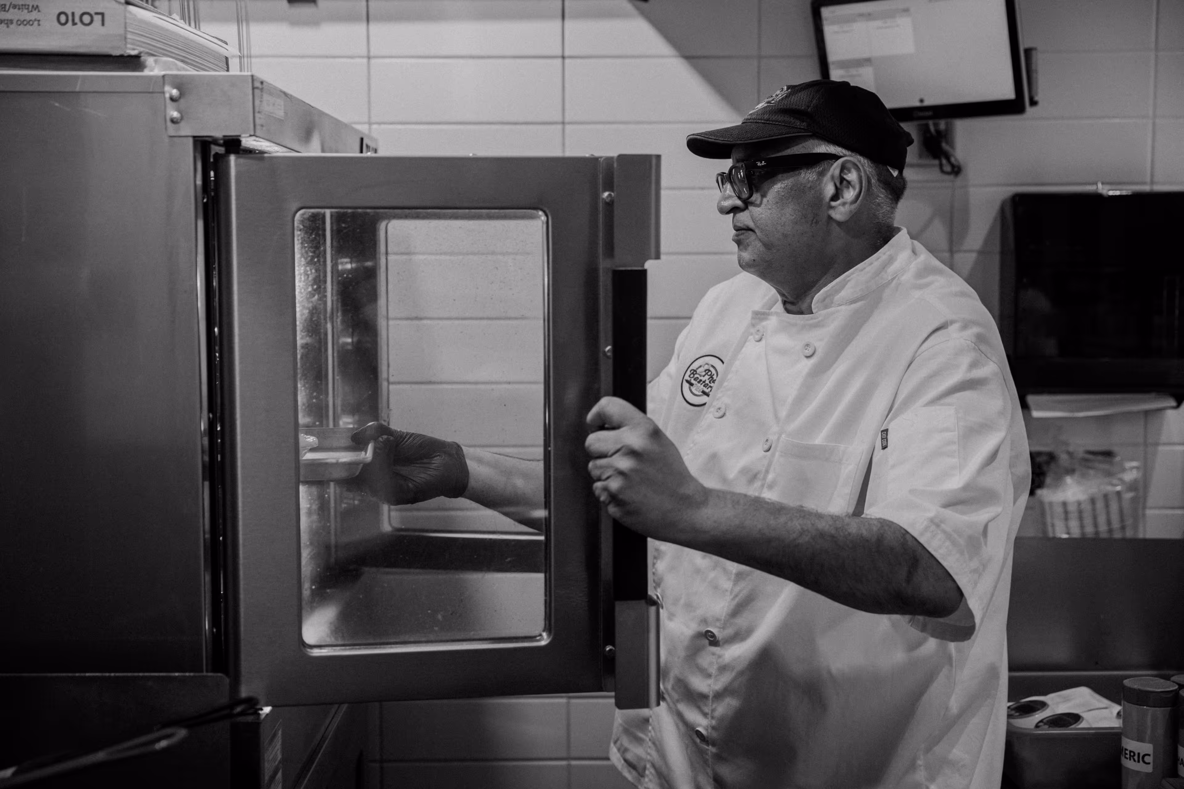 Owner putting pies in the oven
